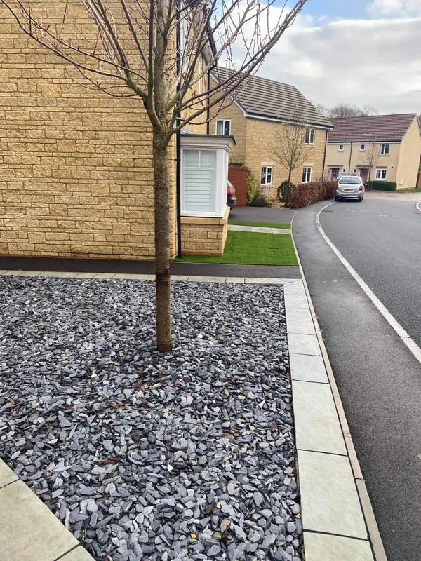 Front and rear garden renovation in Radstock with slate paving and artificial grass