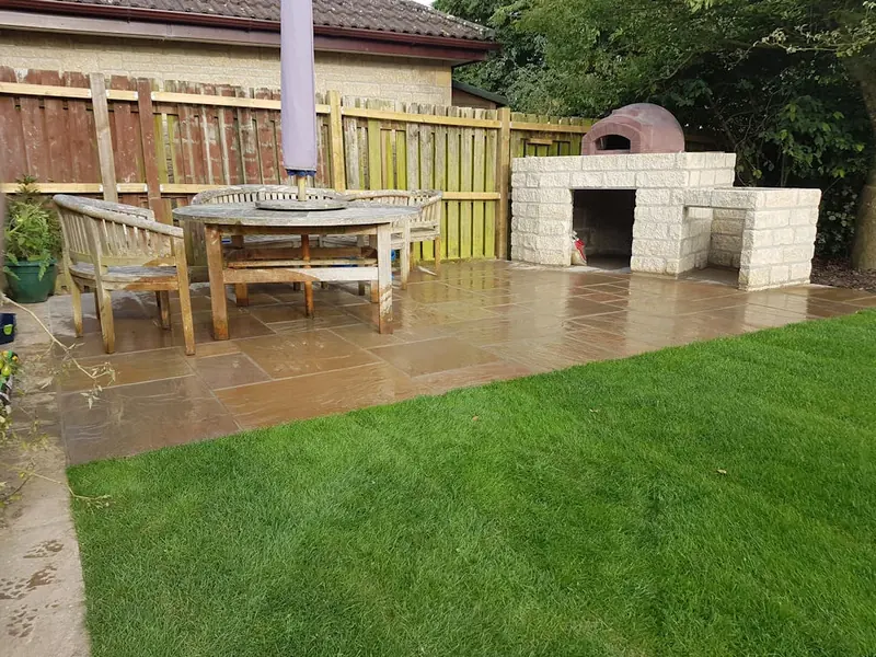 Garden transformation with camel sandstone patio and pizza oven in Timsbury