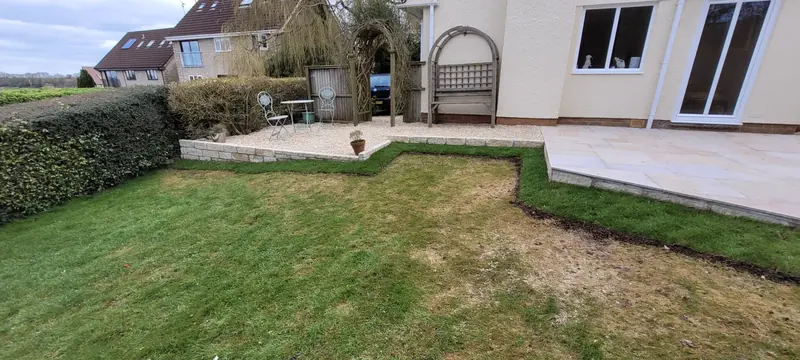 Yellow limestone patio with Cotswold walling and resin jointing in Chilcompton